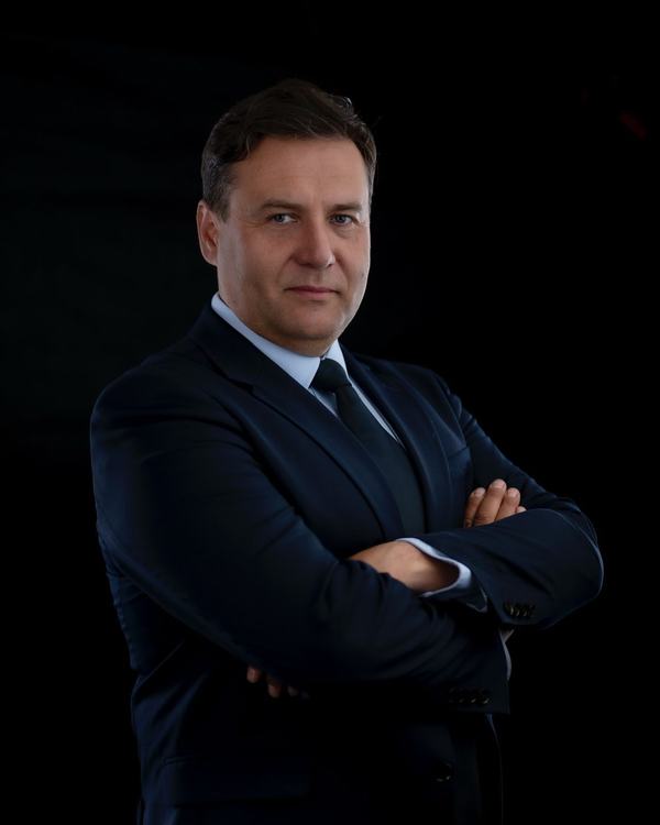 Mężczyzna w garniturze z lekkim uśmiechem, portret do profilu zawodowego, studio w Katowicach
